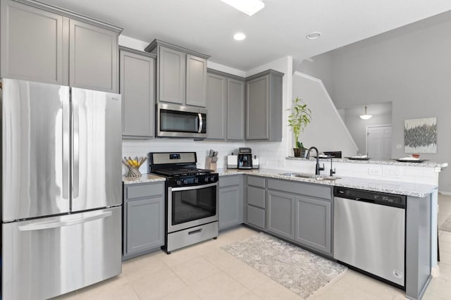 246 Salt Springs Rd, Kyle, TX 78640 - kitchen with appliances with stainless steel finishes, gray cabinetry, a sink, a peninsula, and recessed lighting