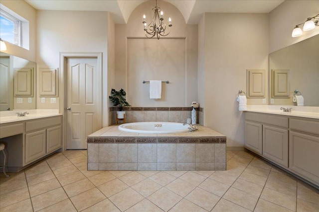 209 Steamboat Xing, Dripping Springs, TX 78620 - full bathroom with a chandelier, tile patterned flooring, a bath, two vanities, and a high ceiling