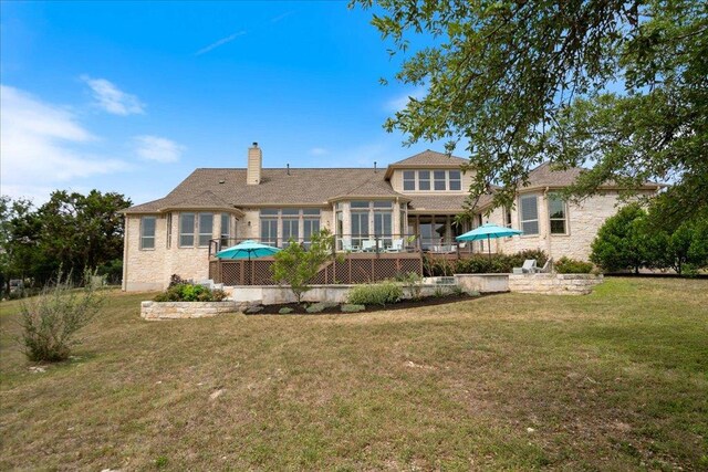 209 Steamboat Xing, Dripping Springs, TX 78620 - back of property with a chimney, a yard, a deck, and a sunroom