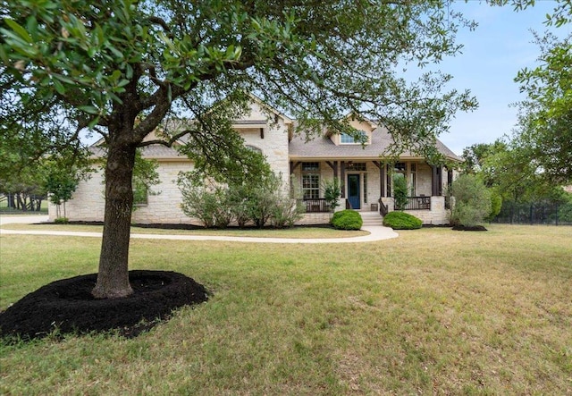 209 Steamboat Xing, Dripping Springs, TX 78620 - view of front of property featuring a front yard, stone siding, and a porch
