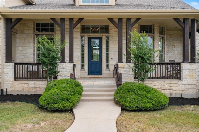 209 Steamboat Xing, Dripping Springs, TX 78620 - entrance to property featuring stone siding, covered porch, and roof with shingles