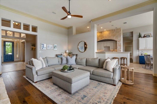 209 Steamboat Xing, Dripping Springs, TX 78620 - living area with ceiling fan, ornamental molding, dark wood-type flooring, recessed lighting, and a towering ceiling