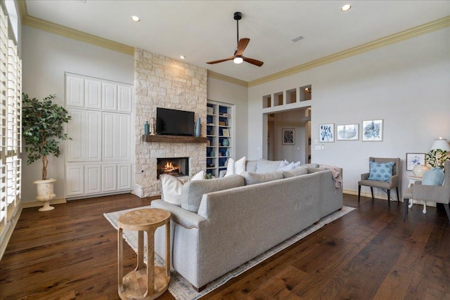 209 Steamboat Xing, Dripping Springs, TX 78620 - living room with ceiling fan, ornamental molding, a stone fireplace, dark wood-style flooring, and baseboards