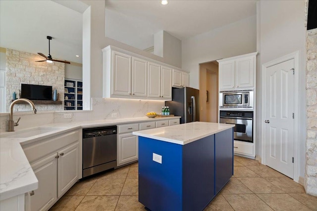 209 Steamboat Xing, Dripping Springs, TX 78620 - kitchen with stainless steel appliances, a sink, ceiling fan, and tasteful backsplash