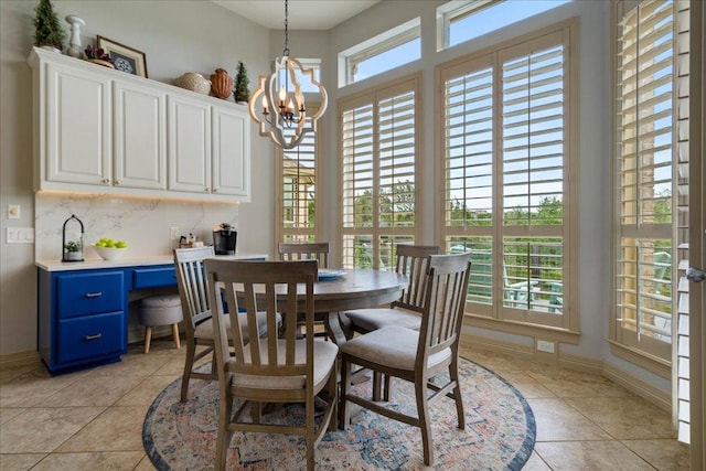 209 Steamboat Xing, Dripping Springs, TX 78620 - dining area with healthy amount of natural light, light tile patterned floors, a chandelier, and baseboards