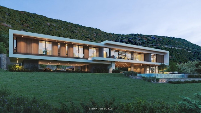 13451 Bullick Hollow Rd, Austin, TX 78726 - rear view of house with a mountain view and a lawn