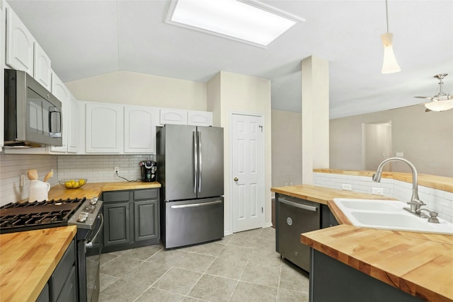 1603 Country Squire Dr, Cedar Park, TX 78613 - kitchen with wooden counters, stainless steel appliances, a sink, decorative backsplash, and white cabinetry