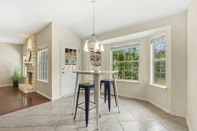 1603 Country Squire Dr, Cedar Park, TX 78613 - dining room featuring baseboards, a chandelier, light tile patterned flooring, vaulted ceiling, and a fireplace
