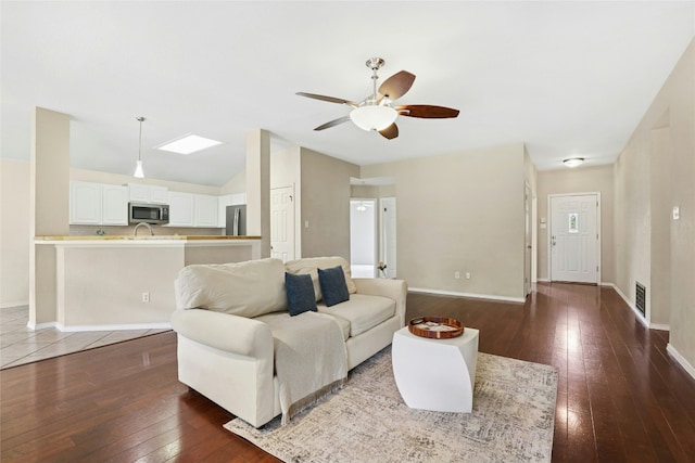 1603 Country Squire Dr, Cedar Park, TX 78613 - living room featuring dark wood finished floors, vaulted ceiling, a ceiling fan, and baseboards