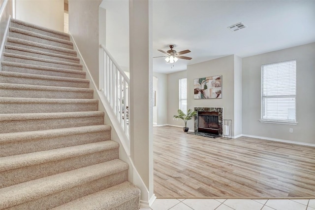 227 Woodlake Dr, Georgetown, TX 78633 - stairway featuring a ceiling fan, wood finished floors, and a high end fireplace