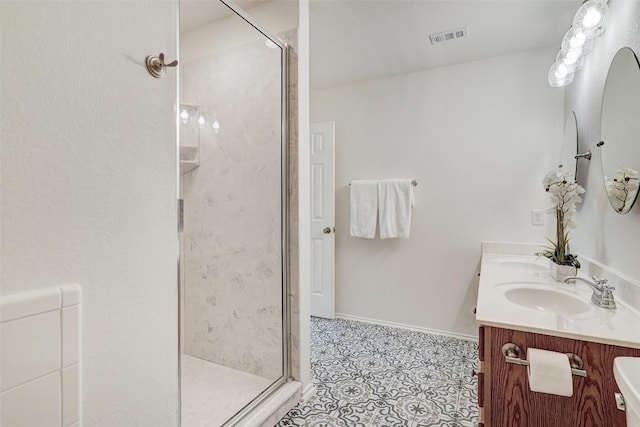 227 Woodlake Dr, Georgetown, TX 78633 - full bath featuring a shower stall, double vanity, and tile patterned floors
