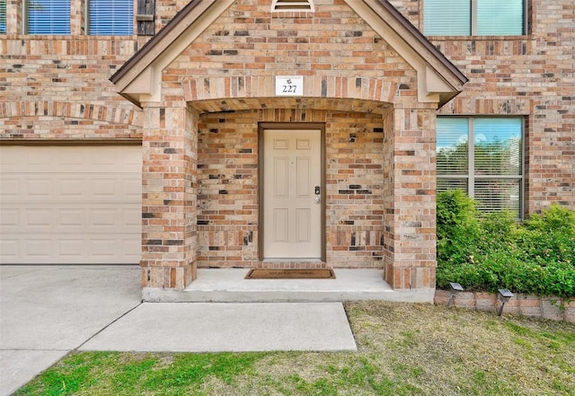 227 Woodlake Dr, Georgetown, TX 78633 - entrance to property featuring a garage and brick siding