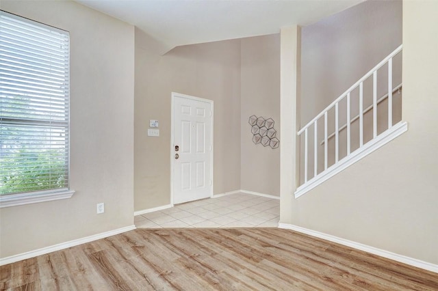 227 Woodlake Dr, Georgetown, TX 78633 - foyer with wood finished floors, stairway, and vaulted ceiling