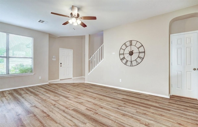 227 Woodlake Dr, Georgetown, TX 78633 - entrance foyer with light wood-style flooring, a ceiling fan, stairs, and arched walkways