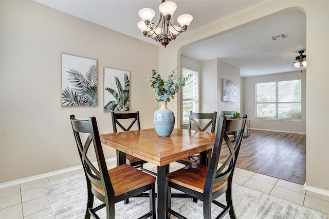 227 Woodlake Dr, Georgetown, TX 78633 - dining space featuring plenty of natural light, arched walkways, light tile patterned floors, and a chandelier