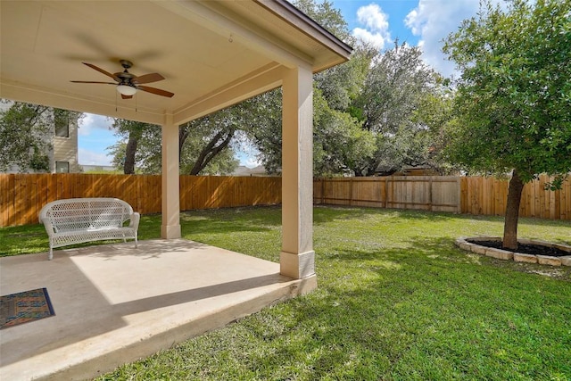 227 Woodlake Dr, Georgetown, TX 78633 - fenced backyard with ceiling fan and a patio