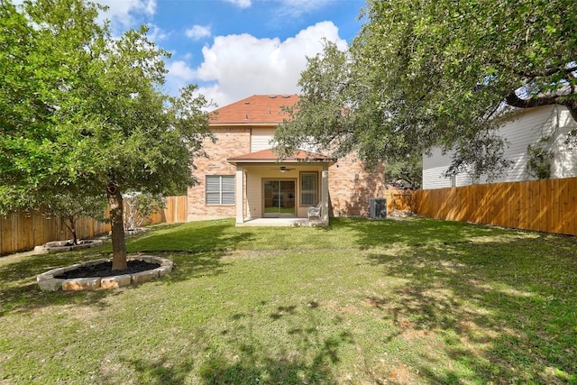 227 Woodlake Dr, Georgetown, TX 78633 - rear view of house featuring a fenced backyard, a patio area, a ceiling fan, and brick siding