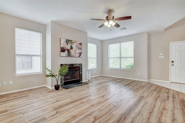 227 Woodlake Dr, Georgetown, TX 78633 - living area featuring wood finished floors, ceiling fan, and a high end fireplace