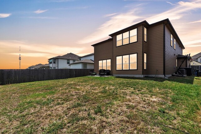 282 Crimson Ln, Kyle, TX 78640 - back of house at dusk featuring a patio area and central AC