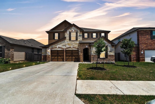 282 Crimson Ln, Kyle, TX 78640 - view of front facade with concrete driveway, stone siding, and a garage