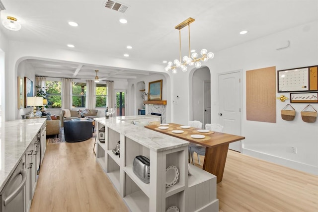 286 Stone View Trl, Austin, TX 78737 - kitchen featuring open shelves, arched walkways, light wood finished floors, open floor plan, and recessed lighting