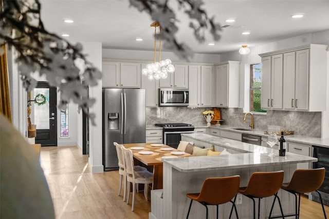 286 Stone View Trl, Austin, TX 78737 - kitchen with appliances with stainless steel finishes, a kitchen bar, a center island, beverage cooler, and recessed lighting