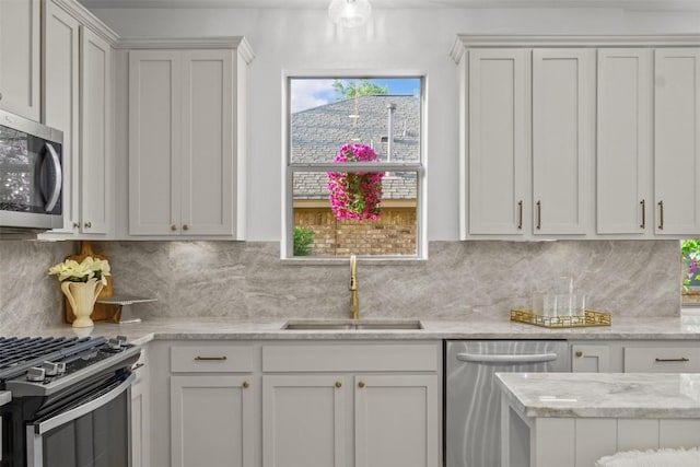 286 Stone View Trl, Austin, TX 78737 - kitchen featuring stainless steel appliances, a sink, backsplash, white cabinets, and light stone countertops
