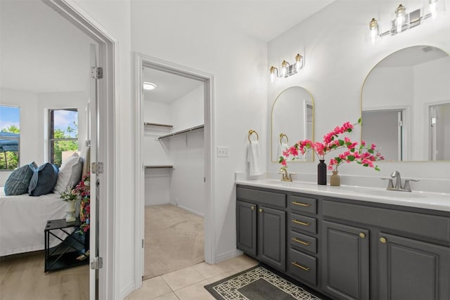 286 Stone View Trl, Austin, TX 78737 - bathroom with ensuite bathroom, double vanity, tile patterned flooring, and baseboards