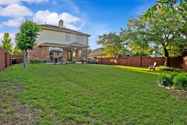286 Stone View Trl, Austin, TX 78737 - back of property featuring a chimney, brick siding, and a patio