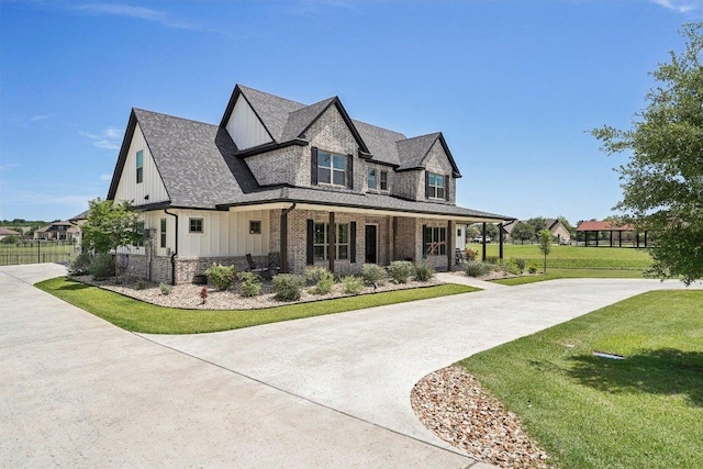 795 Van Bibber Rd, Salado, TX 76571 - view of front of home with a porch, board and batten siding, a front lawn, brick siding, and a shingled roof