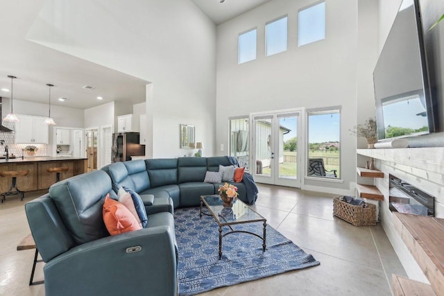 795 Van Bibber Rd, Salado, TX 76571 - living area featuring a towering ceiling, recessed lighting, a fireplace, baseboards, and french doors