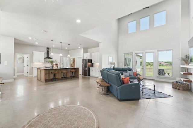 795 Van Bibber Rd, Salado, TX 76571 - living room featuring a towering ceiling, recessed lighting, and baseboards