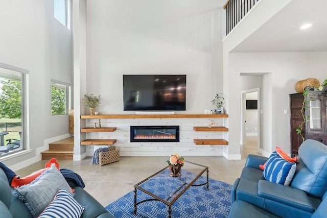 795 Van Bibber Rd, Salado, TX 76571 - living area with a high ceiling, tile patterned floors, baseboards, a glass covered fireplace, and recessed lighting