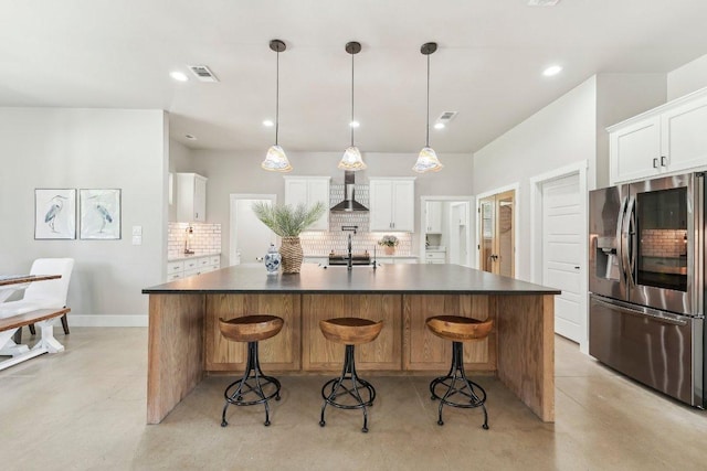 795 Van Bibber Rd, Salado, TX 76571 - kitchen with stainless steel fridge with ice dispenser, wall chimney exhaust hood, backsplash, dark countertops, and recessed lighting