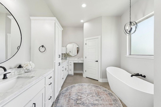 795 Van Bibber Rd, Salado, TX 76571 - bathroom with a freestanding bath, two vanities, recessed lighting, and baseboards
