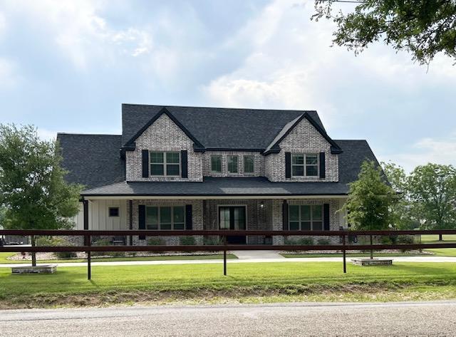 795 Van Bibber Rd, Salado, TX 76571 - view of front of house with covered porch, board and batten siding, and brick siding