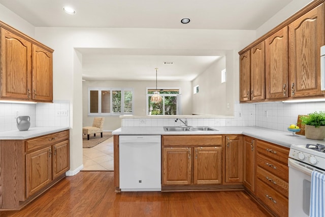 403 Dove Hollow Trl, Georgetown, TX 78633 - kitchen with white appliances, a peninsula, dark wood-style flooring, light countertops, and recessed lighting