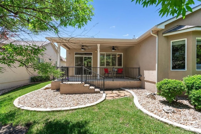 403 Dove Hollow Trl, Georgetown, TX 78633 - back of house with ceiling fan, stucco siding, and a yard