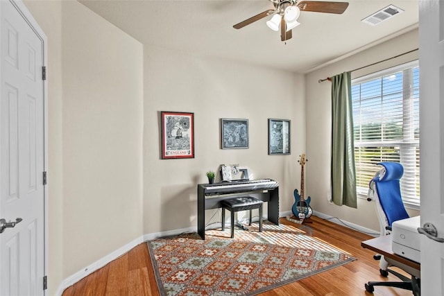 office with ceiling fan, baseboards, and wood finished floors