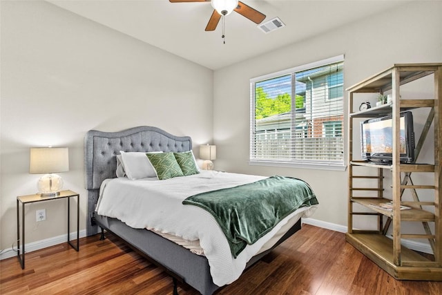 bedroom featuring wood finished floors and baseboards