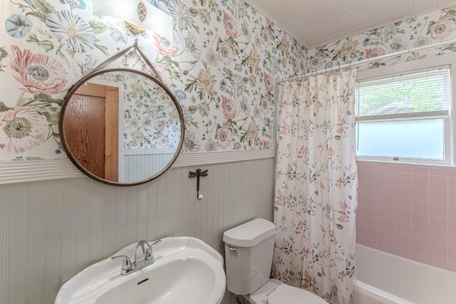 1408 W Clark St, Bartlett, TX 76511 - bathroom with wallpapered walls, a sink, shower / bath combo, toilet, and a wainscoted wall