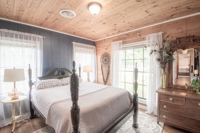 1408 W Clark St, Bartlett, TX 76511 - bedroom featuring wooden ceiling, crown molding, wood walls, and wood finished floors