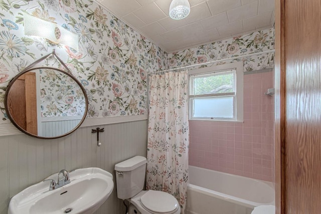 1408 W Clark St, Bartlett, TX 76511 - bathroom featuring a sink, wallpapered walls, toilet, shower / bath combination with curtain, and wainscoting