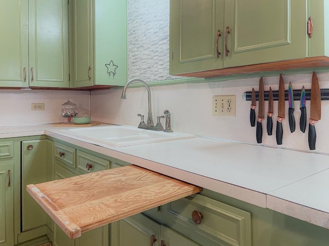 1408 W Clark St, Bartlett, TX 76511 - kitchen with green cabinetry, a sink, and light countertops