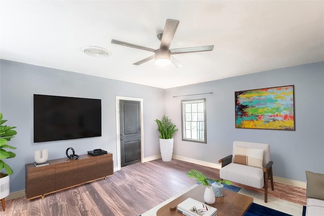 1408 W Clark St, Bartlett, TX 76511 - living area with wood finished floors, ceiling fan, and baseboards