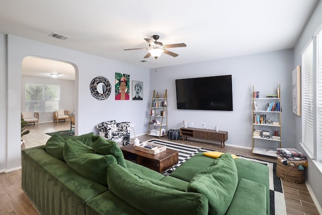 8716 Panadero Dr, Austin, TX 78747 - living room featuring arched walkways, plenty of natural light, ceiling fan, and wood finished floors