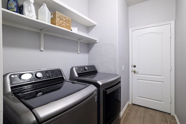 8716 Panadero Dr, Austin, TX 78747 - laundry room with washer and clothes dryer and wood finished floors