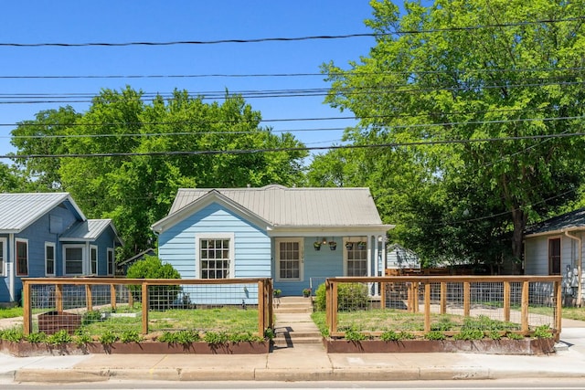 bungalow-style home featuring metal roof and a porch