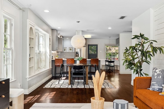 dining space with wood finished floors, baseboards, and recessed lighting