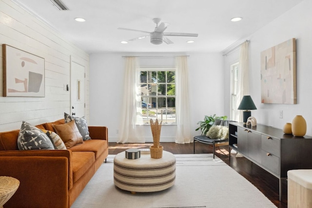 living area featuring dark wood-style flooring, wood walls, recessed lighting, and ceiling fan